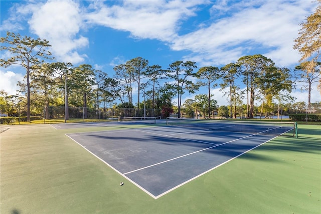 view of tennis court featuring fence