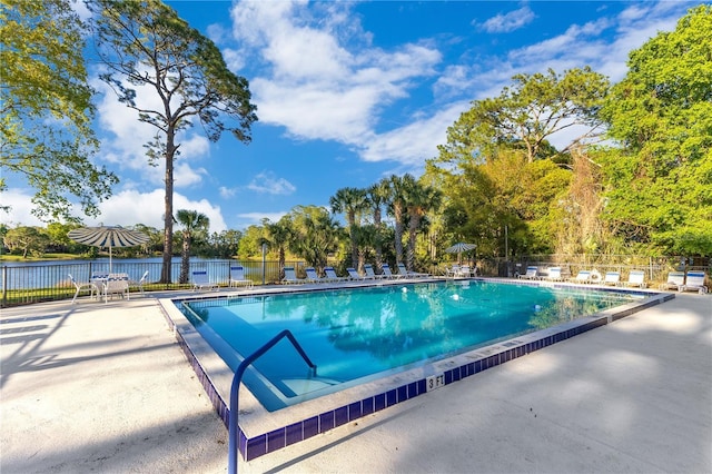 community pool featuring a patio area and fence