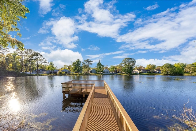 view of dock with a residential view and a water view