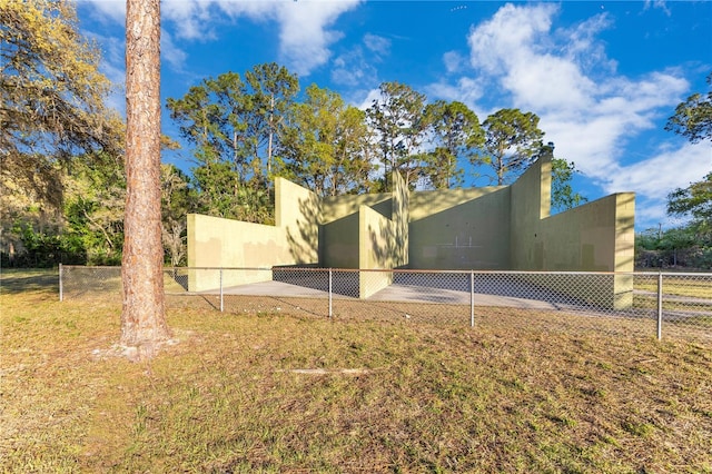 rear view of property featuring stucco siding and fence