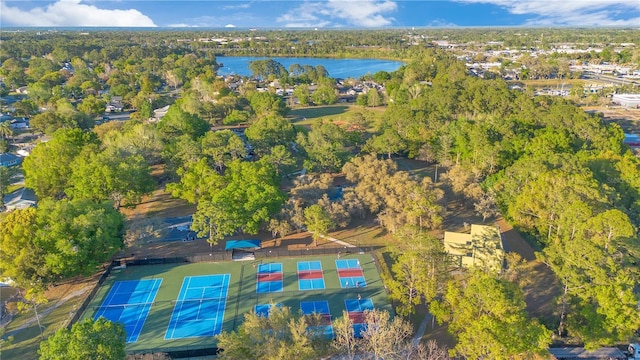 birds eye view of property featuring a water view and a view of trees