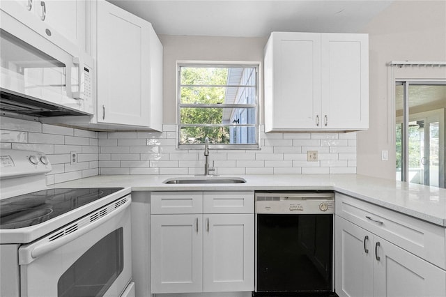 4751 Deer Run Rd, Saint Cloud, FL 34772 - kitchen with decorative backsplash, white appliances, white cabinetry, and a sink