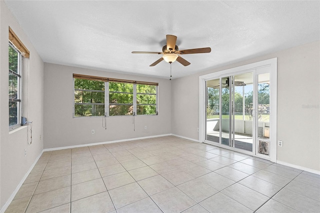 4751 Deer Run Rd, Saint Cloud, FL 34772 - spare room with light tile patterned floors, a textured ceiling, baseboards, and ceiling fan