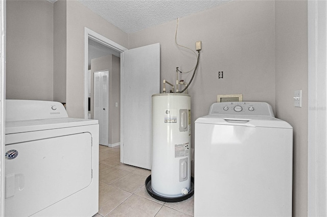 4751 Deer Run Rd, Saint Cloud, FL 34772 - laundry room with laundry area, light tile patterned flooring, a textured ceiling, washing machine and dryer, and electric water heater