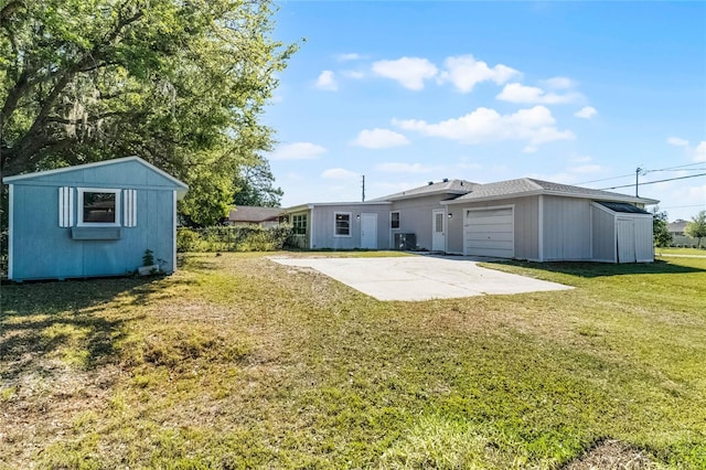 4751 Deer Run Rd, Saint Cloud, FL 34772 - rear view of property with an outbuilding, a lawn, and a garage
