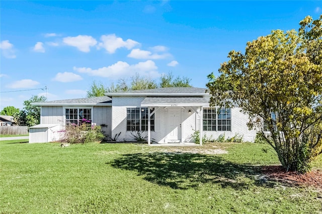 4751 Deer Run Rd, Saint Cloud, FL 34772 - rear view of property featuring a yard and brick siding