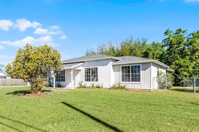4751 Deer Run Rd, Saint Cloud, FL 34772 - view of front of house featuring board and batten siding, a front yard, and fence