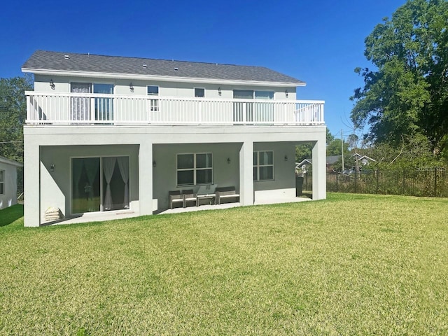 back of house featuring a yard, a patio, fence, and stucco siding