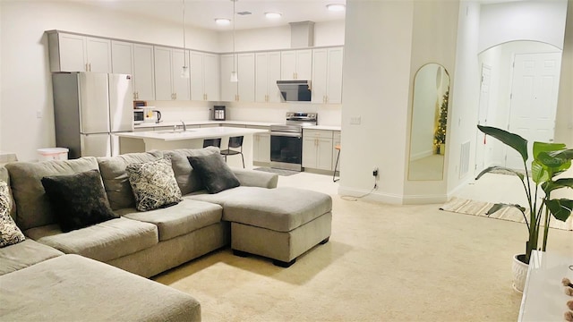 living room with baseboards, light carpet, and visible vents