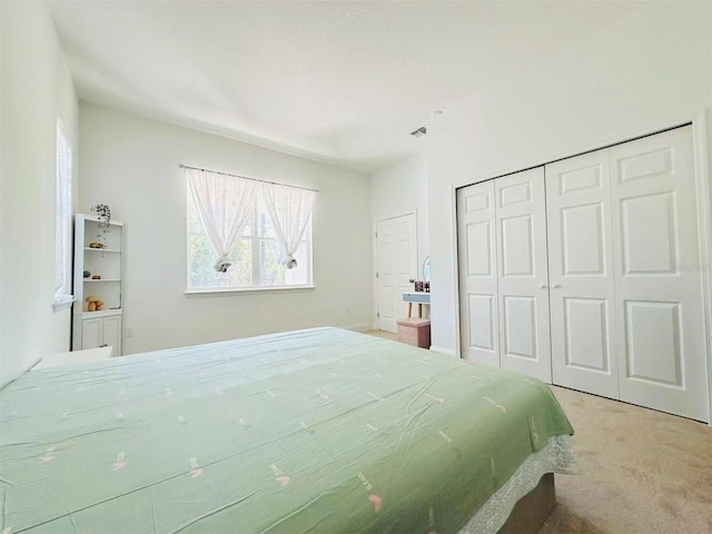 carpeted bedroom with a closet and visible vents