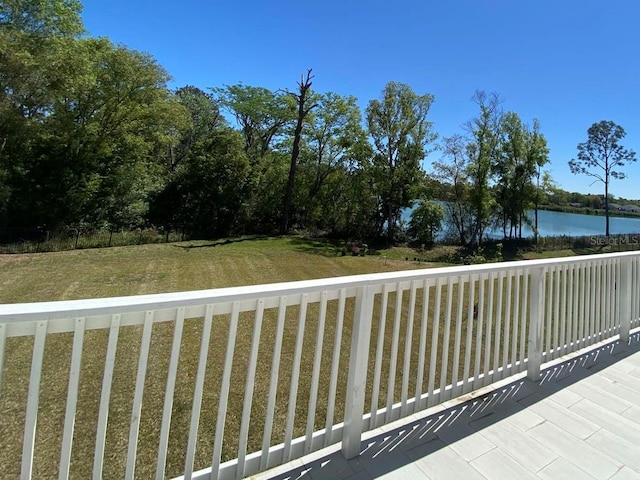exterior space with a water view and a lawn