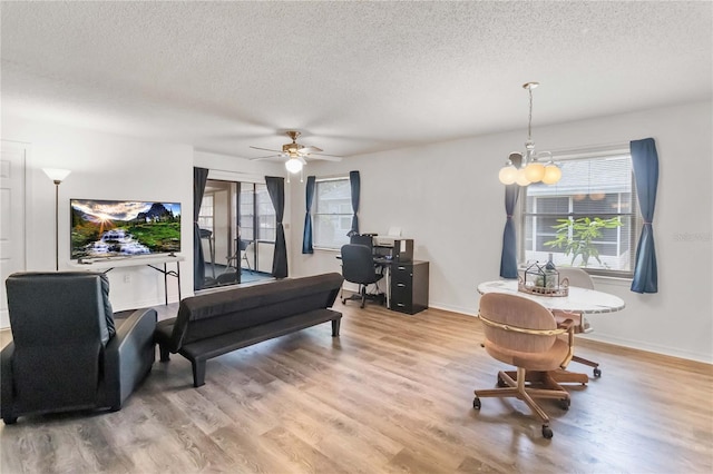 1148 Monroe Ave, Saint Cloud, FL 34769 - living room featuring a textured ceiling, wood finished floors, a chandelier, a desk, and ceiling fan