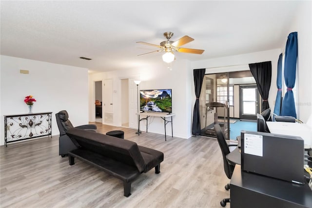 1148 Monroe Ave, Saint Cloud, FL 34769 - living area featuring ceiling fan, a desk, light wood finished floors, and baseboards