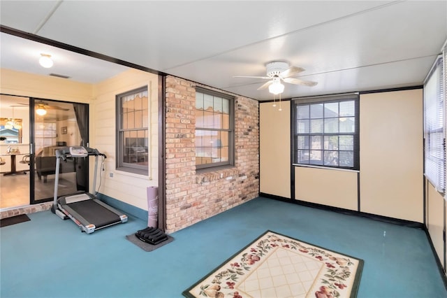1148 Monroe Ave, Saint Cloud, FL 34769 - workout area featuring a ceiling fan and brick wall