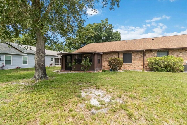 1148 Monroe Ave, Saint Cloud, FL 34769 - view of grassy yard featuring a sunroom