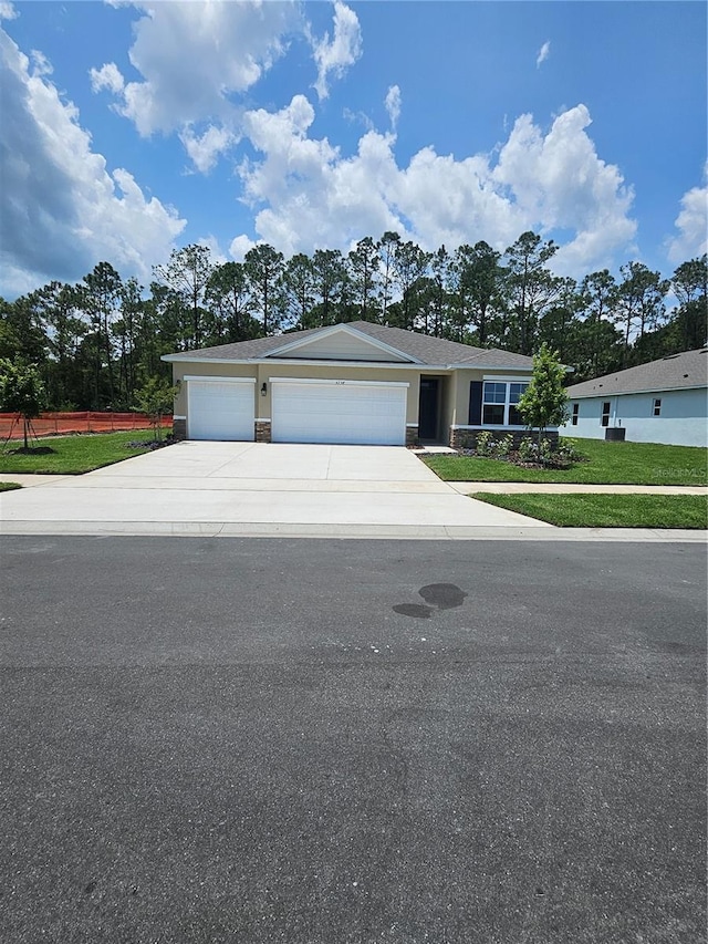 4238 Acoma Dr, Ormond Beach, FL 32174 - ranch-style house featuring concrete driveway, an attached garage, a front lawn, and stone siding