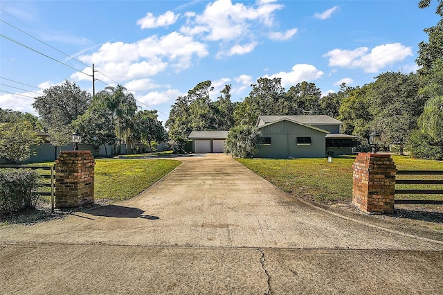1661 Votaw Rd, Apopka, FL 32703 - view of front of house with a garage, concrete driveway, a front lawn, and fence