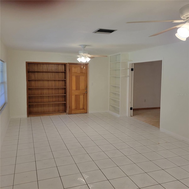1661 Votaw Rd, Apopka, FL 32703 - unfurnished room with light tile patterned floors, visible vents, built in shelves, and ceiling fan
