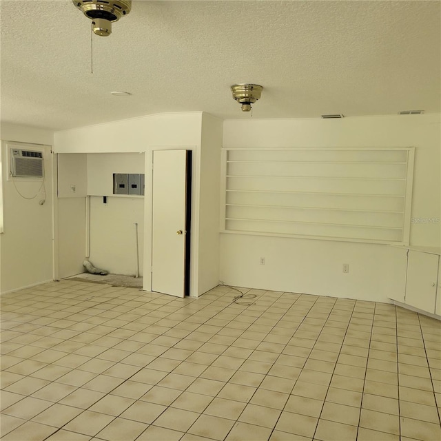 1661 Votaw Rd, Apopka, FL 32703 - empty room featuring a wall mounted air conditioner, visible vents, a textured ceiling, and light tile patterned floors