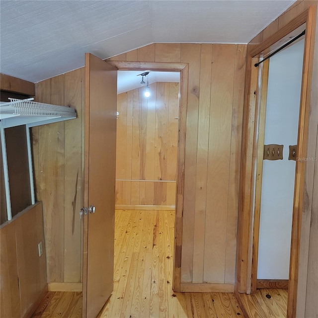 1661 Votaw Rd, Apopka, FL 32703 - corridor featuring vaulted ceiling, wooden walls, and wood finished floors