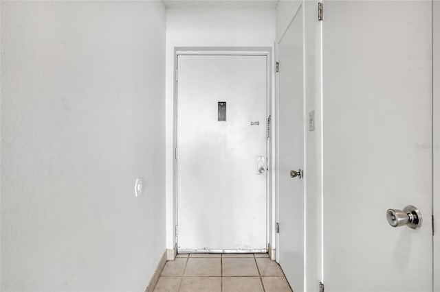 2465 S Washington Ave Unit A402, Titusville, FL 32780 - hall featuring light tile patterned floors and baseboards