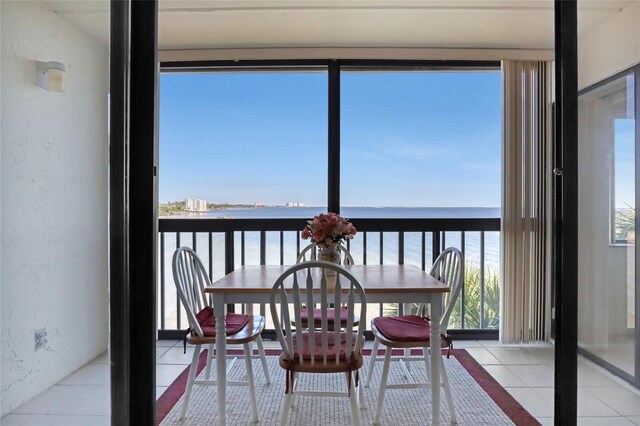 2465 S Washington Ave Unit A402, Titusville, FL 32780 - sunroom with tile patterned flooring, a textured wall, and a water view