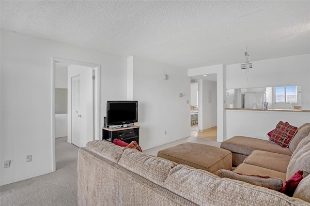 2465 S Washington Ave Unit A402, Titusville, FL 32780 - living area featuring light carpet, visible vents, and a textured ceiling