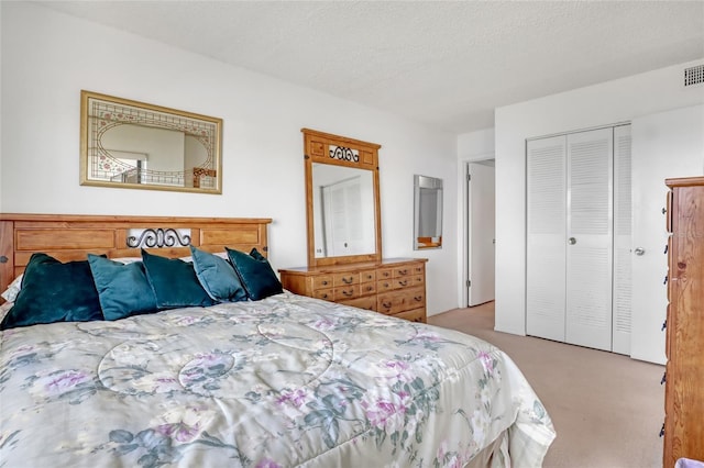 2465 S Washington Ave Unit A402, Titusville, FL 32780 - bedroom featuring visible vents, carpet, a closet, and a textured ceiling