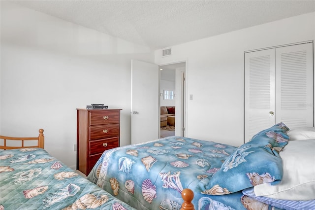 2465 S Washington Ave Unit A402, Titusville, FL 32780 - bedroom featuring a closet, visible vents, and a textured ceiling