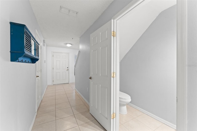 435 Tradition Ln, Winter Springs, FL 32708 - hall with light tile patterned floors, a textured ceiling, baseboards, and visible vents