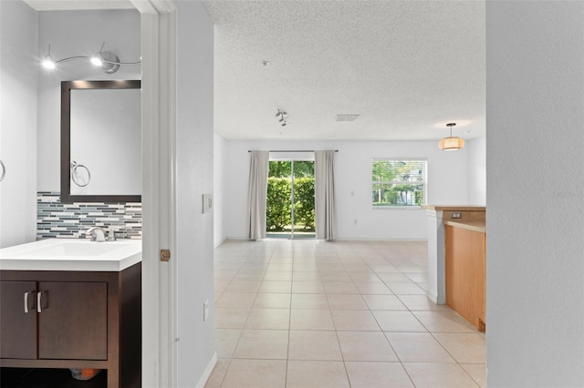 435 Tradition Ln, Winter Springs, FL 32708 - interior space with vanity, a textured ceiling, decorative backsplash, tile patterned floors, and visible vents