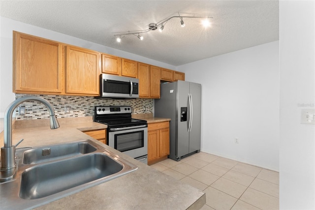 435 Tradition Ln, Winter Springs, FL 32708 - kitchen featuring light tile patterned flooring, light countertops, appliances with stainless steel finishes, a sink, and backsplash