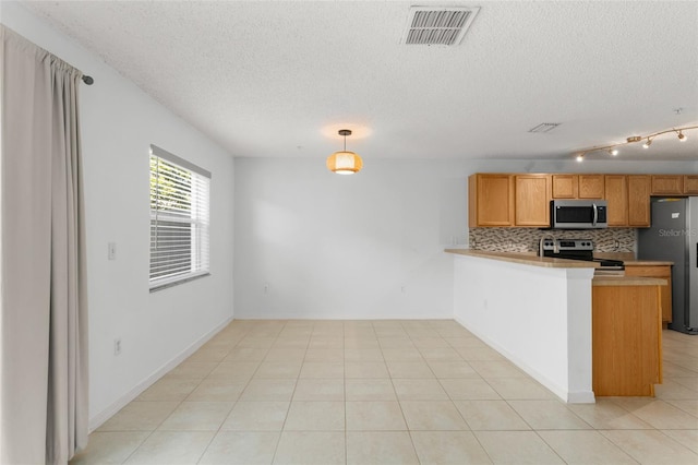 435 Tradition Ln, Winter Springs, FL 32708 - kitchen with tasteful backsplash, appliances with stainless steel finishes, a textured ceiling, a peninsula, and visible vents