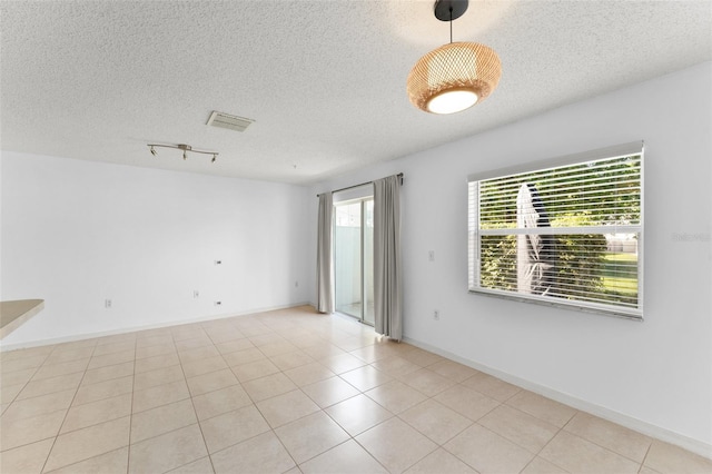 435 Tradition Ln, Winter Springs, FL 32708 - tiled empty room with baseboards, a textured ceiling, and visible vents