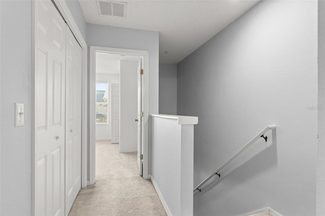 435 Tradition Ln, Winter Springs, FL 32708 - hallway with light colored carpet, visible vents, an upstairs landing, and baseboards