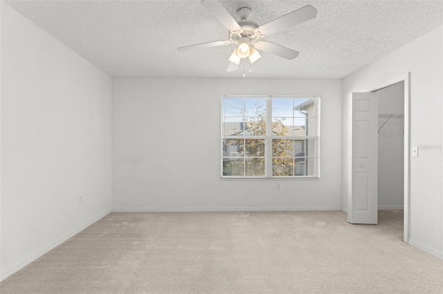435 Tradition Ln, Winter Springs, FL 32708 - unfurnished bedroom with ceiling fan, a walk in closet, light colored carpet, and a textured ceiling
