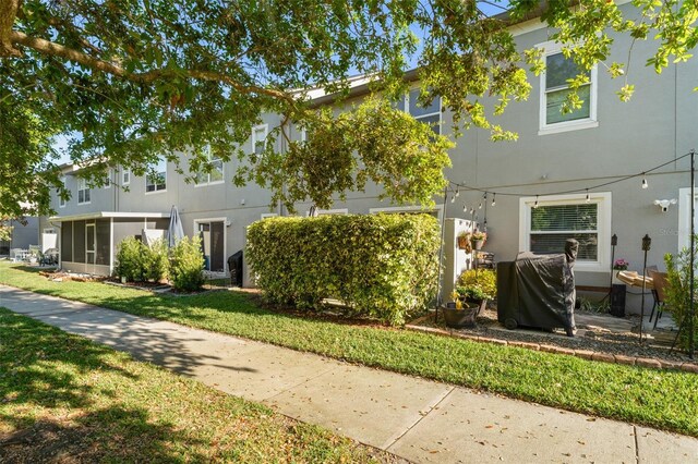 435 Tradition Ln, Winter Springs, FL 32708 - multi unit property with a front lawn, stucco siding, and a sunroom