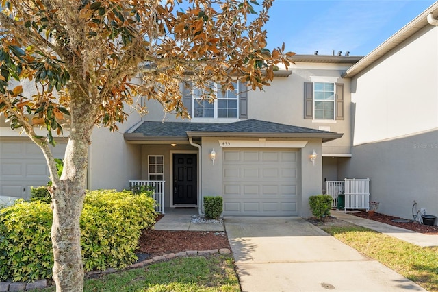 435 Tradition Ln, Winter Springs, FL 32708 - townhome / multi-family property featuring a shingled roof, stucco siding, and concrete driveway