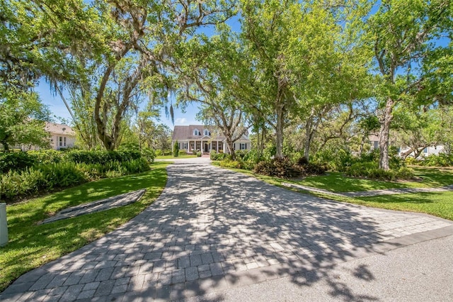 1570 Oakford Rd, Sarasota, FL 34240 - cape cod-style house featuring a front lawn and decorative driveway