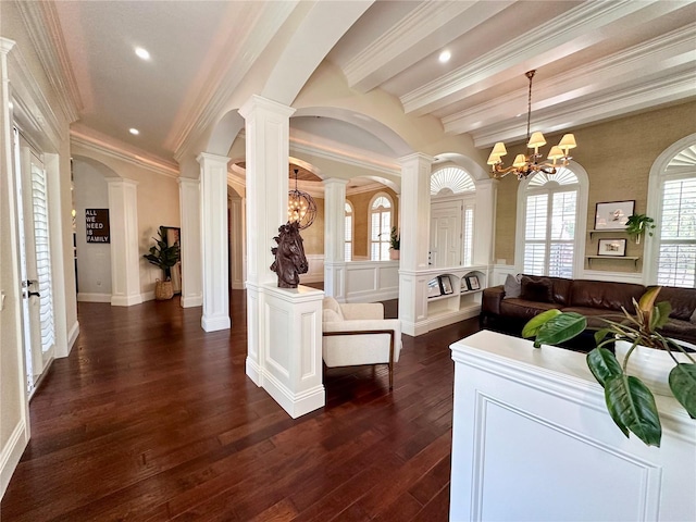 1570 Oakford Rd, Sarasota, FL 34240 - living area featuring dark wood-style floors, a chandelier, ornamental molding, beamed ceiling, and decorative columns