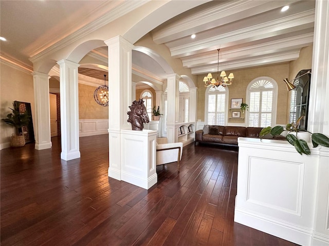 1570 Oakford Rd, Sarasota, FL 34240 - living room with a chandelier, ornate columns, dark wood-style flooring, a decorative wall, and beamed ceiling