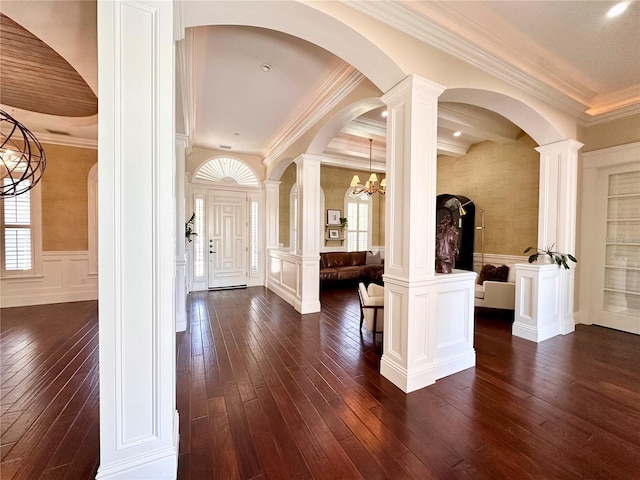 1570 Oakford Rd, Sarasota, FL 34240 - entryway featuring dark wood-type flooring, a chandelier, arched walkways, crown molding, and a wainscoted wall