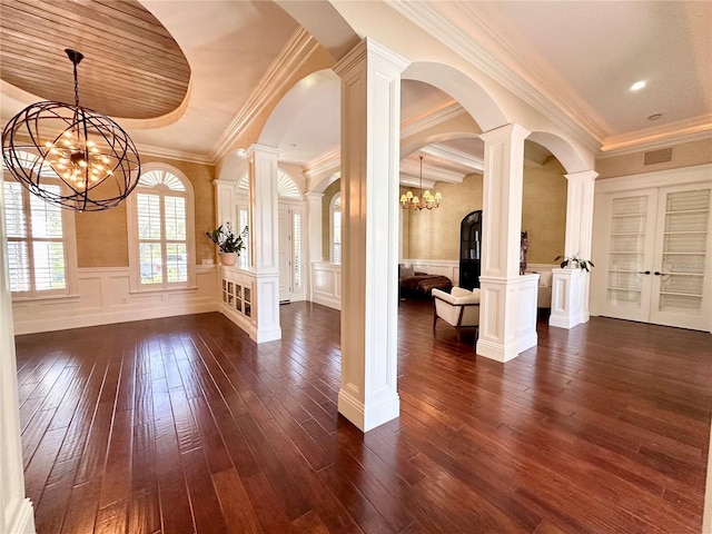 1570 Oakford Rd, Sarasota, FL 34240 - foyer with a chandelier, dark wood-style floors, wainscoting, arched walkways, and ornate columns