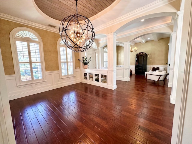 1570 Oakford Rd, Sarasota, FL 34240 - unfurnished dining area featuring a chandelier, arched walkways, dark wood-style flooring, a raised ceiling, and wainscoting