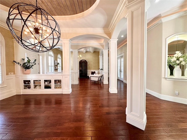 1570 Oakford Rd, Sarasota, FL 34240 - entryway featuring ornate columns, arched walkways, dark wood finished floors, a chandelier, and ornamental molding