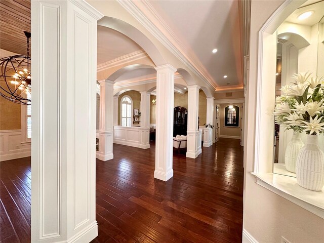 1570 Oakford Rd, Sarasota, FL 34240 - foyer featuring a decorative wall, dark wood-type flooring, crown molding, a wainscoted wall, and decorative columns