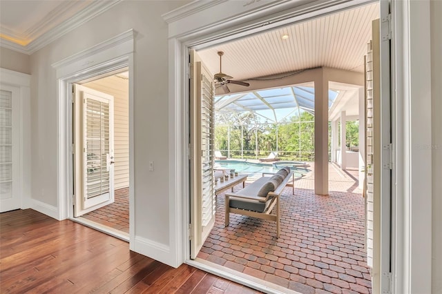 1570 Oakford Rd, Sarasota, FL 34240 - doorway featuring a sunroom, ceiling fan, wood-type flooring, ornamental molding, and baseboards
