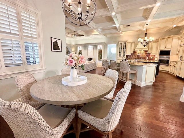 1570 Oakford Rd, Sarasota, FL 34240 - dining space with a chandelier, dark wood-type flooring, beam ceiling, coffered ceiling, and crown molding
