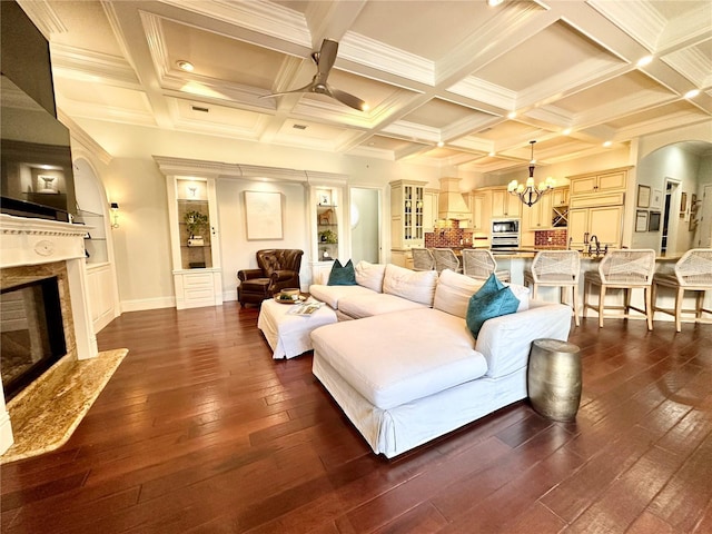 1570 Oakford Rd, Sarasota, FL 34240 - living room featuring a high end fireplace, dark wood-type flooring, ceiling fan, a chandelier, and arched walkways