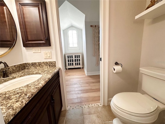 1570 Oakford Rd, Sarasota, FL 34240 - bathroom with toilet, lofted ceiling, baseboards, vanity, and wood finished floors